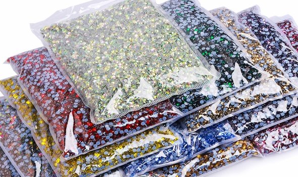 Mixed-color hotfix rhinestone bags stacked for wholesale